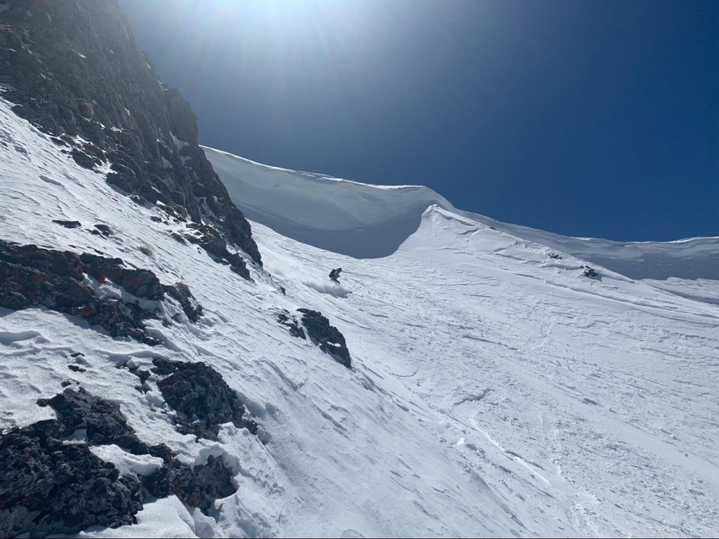 Skiing under a large cornice. Photo: Sergei Poljak. Avalanche Safety