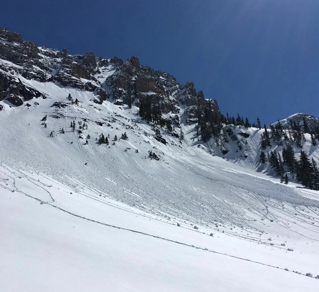 Little point releases sloughing off a sunny cliff after fresh snow on a spring day. Photo: Sergei Poljak. Avalanche Safety
