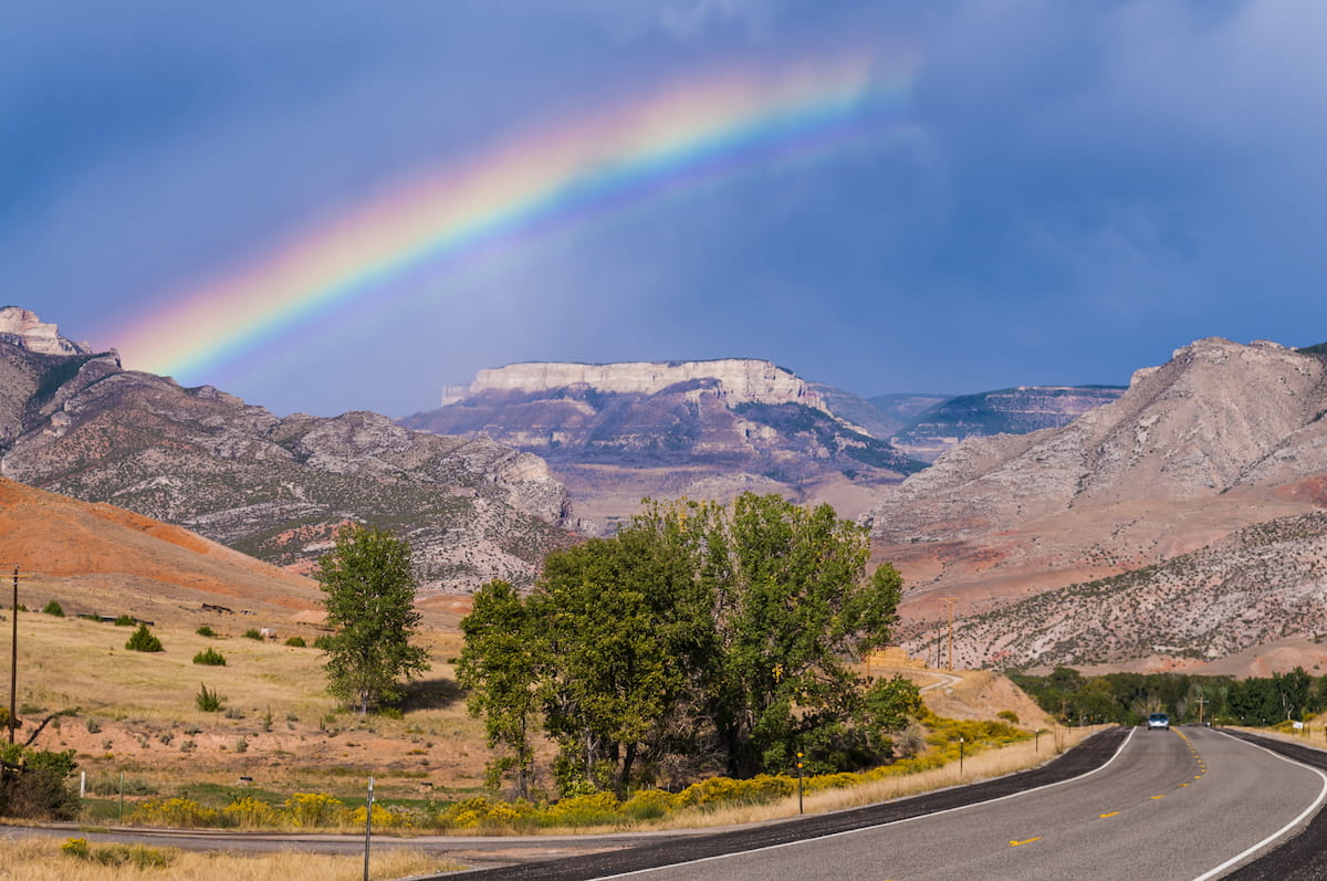 Rainbow over the road leading to Bighorn National Forest
