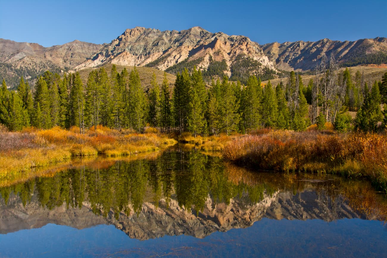 Evergreens and Boulder Mountains, autumn reflection, Big Wood River