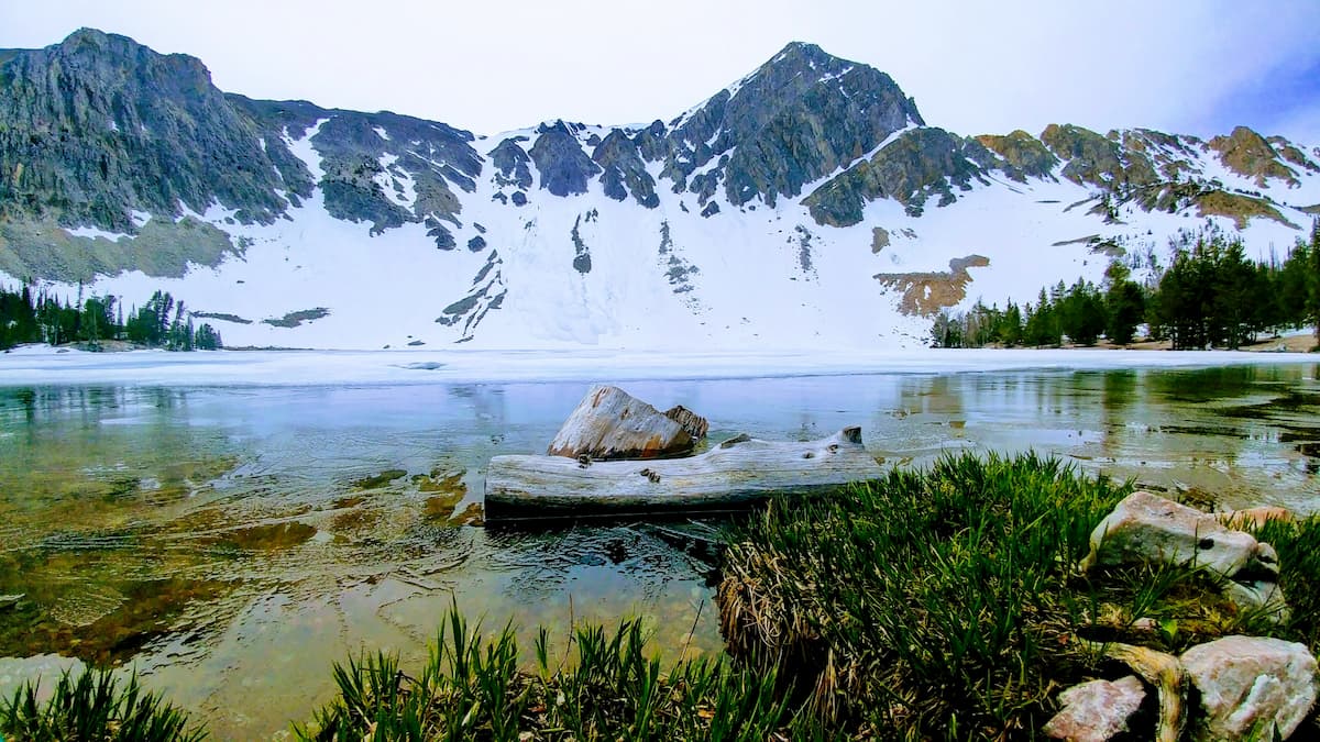 Snowy mountain reflecting off Meadow lake Idaho