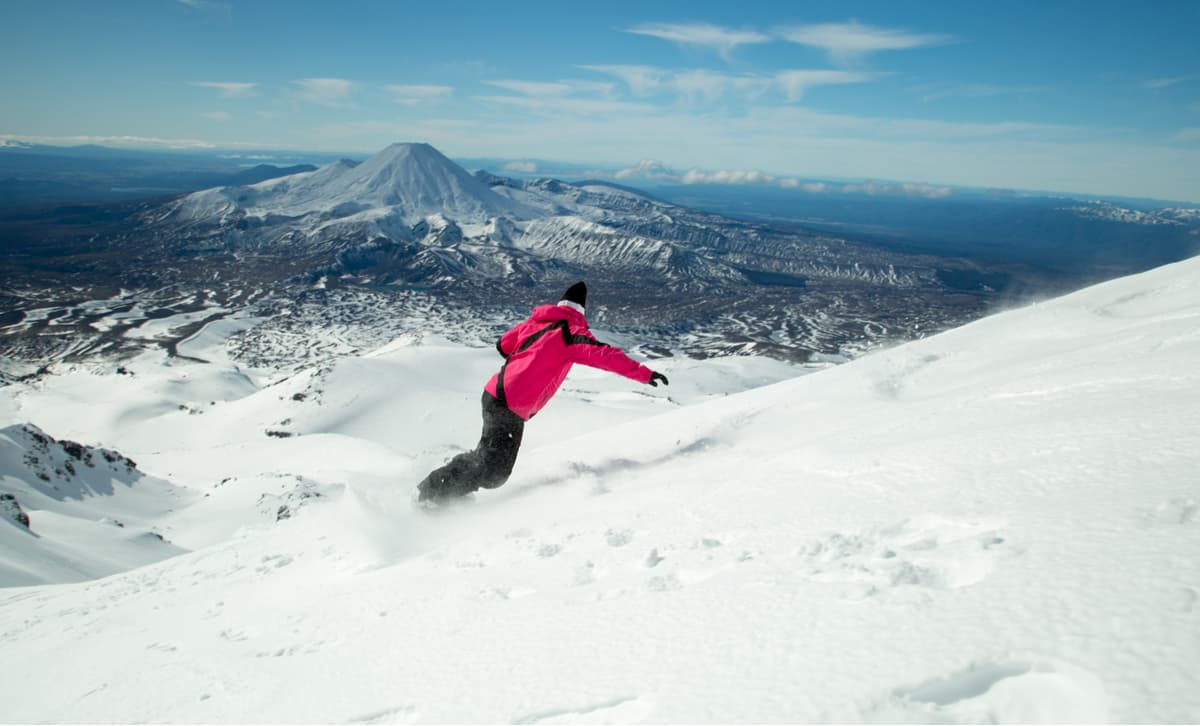 Snowboarding on Mount Ruapehu, view toward Mount Ngauruhoe