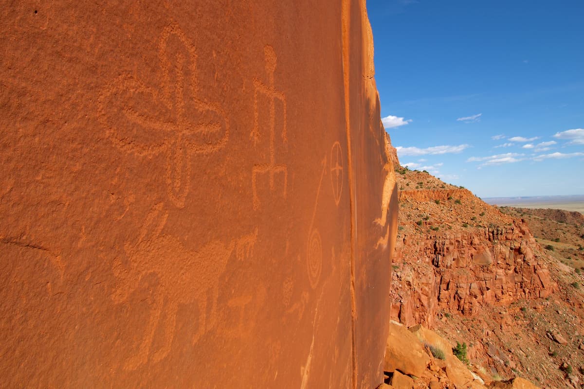 Wide angle view of petroglyphs carved into rock surface by prehistoric Native American(s). Vermilion Cliffs, Northern Arizona desert