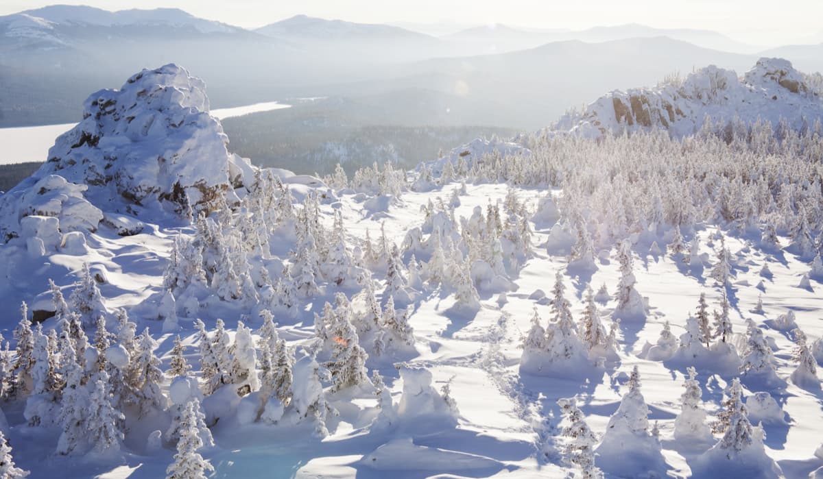 The Zuratkul Ridge and the Bear Rocks. Snow covered spruces and rocks.
