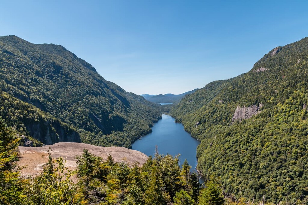 Mountain lake surrounded by forest, Adirondack Park, United States