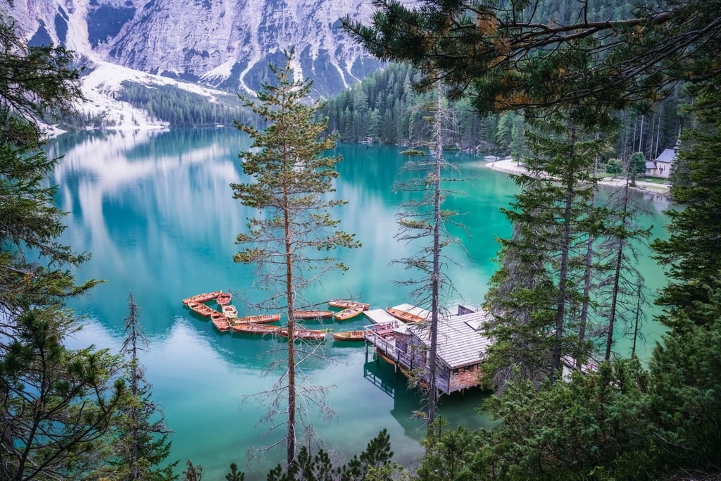 Lake, wooden boats, Braies Dolomites, Italy