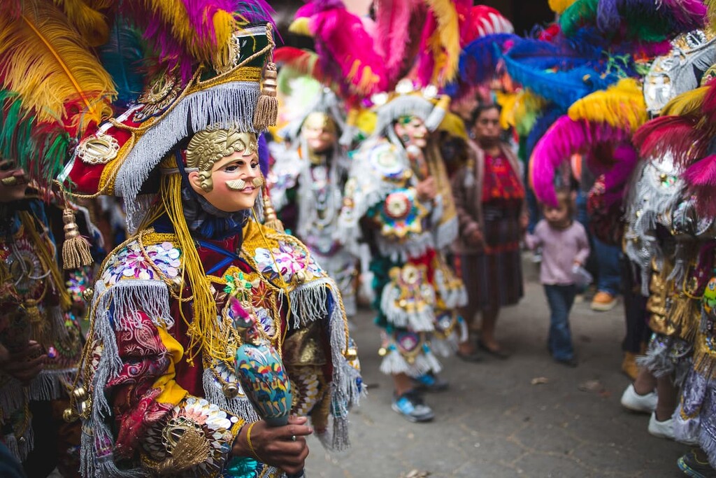 Traditional folk dancer in mask & costume for Dance of the Moors & Christians in village near Spanish colonial town & UNESCO World Heritage Site of Antigua, Guatemala