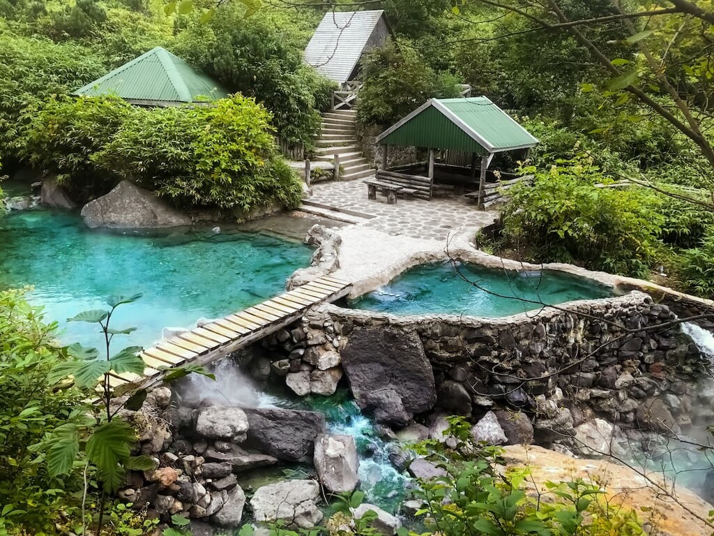 Hot springs with emerald color water near of the Baransky volcano, Kuril Islands