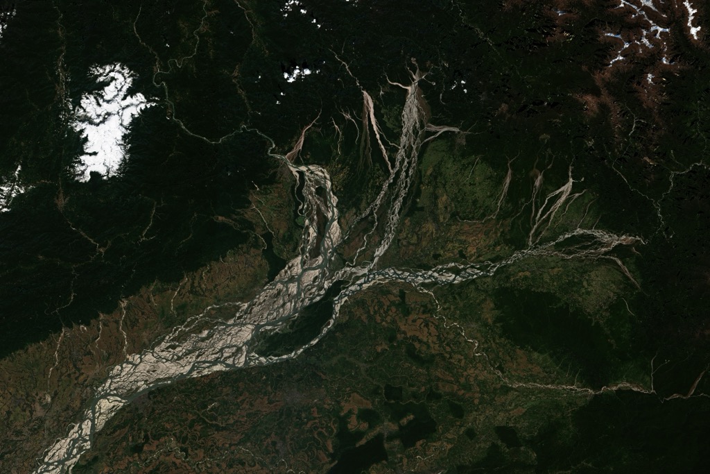 A satellite image of the braided Brahmaputra and the surrounding valley and patchwork of farms. Assam Mountains