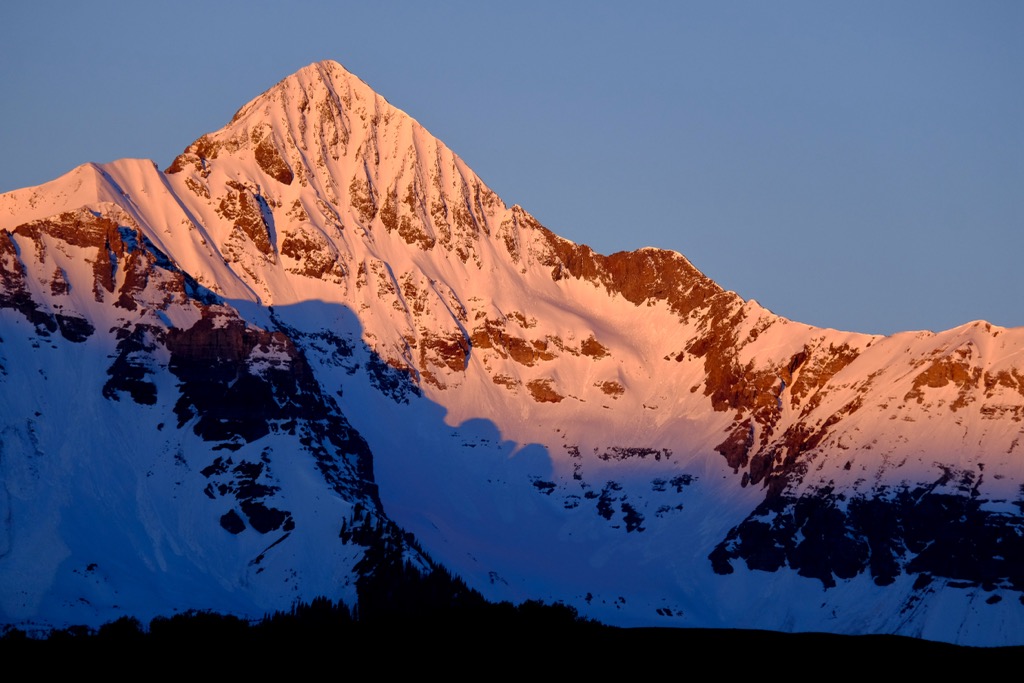 The Coors Face of Wilson Peak in Alpenglow. The main couloir descent is visible in the center of the face. Backcountry Telluride