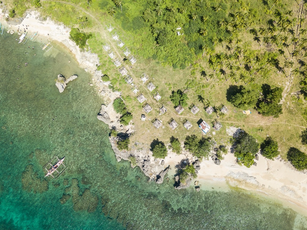 Rocky beach and shoreline in Laiya Batangas. Batangas Mountains