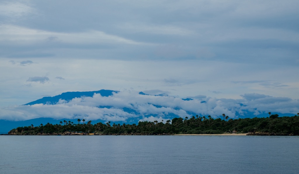 Verde Island Passage is shrouded in misty clouds and fog. Batangas Mountains