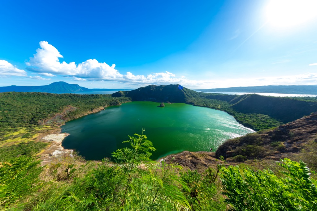 Taal Lake surrounds the cones of Taal Volcano. Batangas Mountains