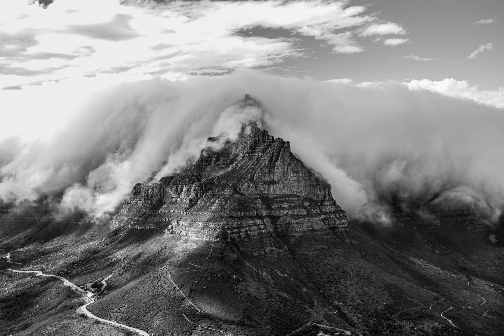 Table Mountain’s rock strata are visible through the peculiar cloud formation known as the “tablecloth.”. Cape Town