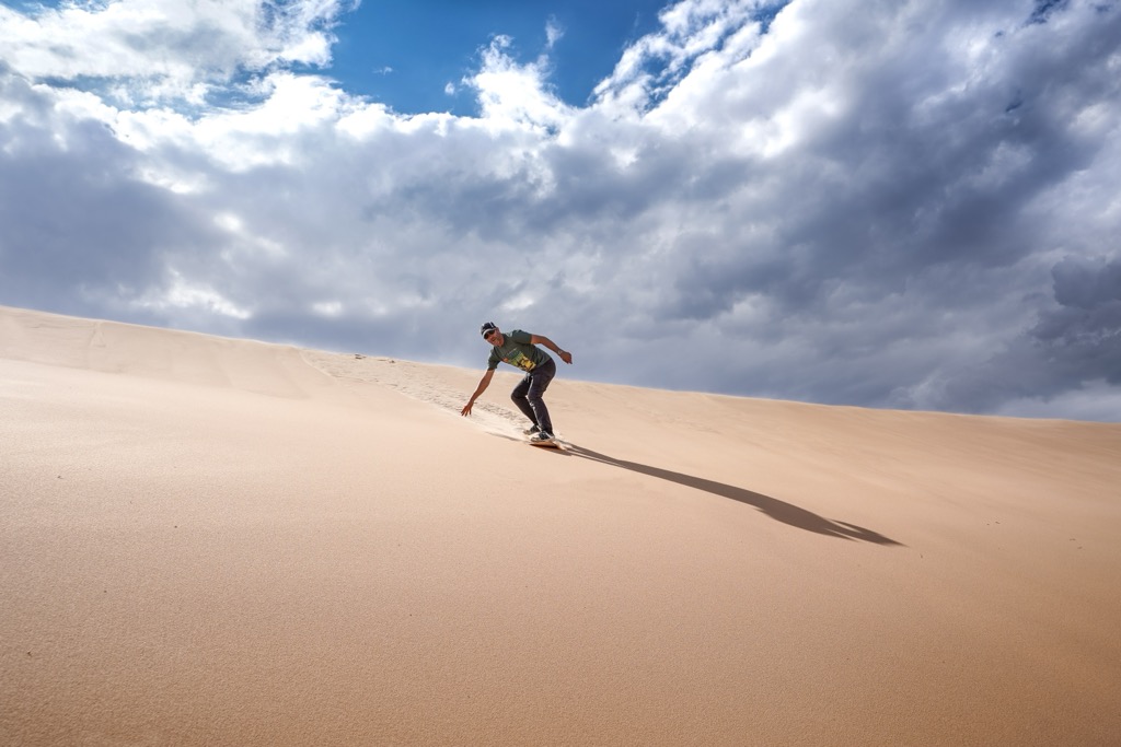 Sandboarding on the Witsand dune. Eden District Municipality