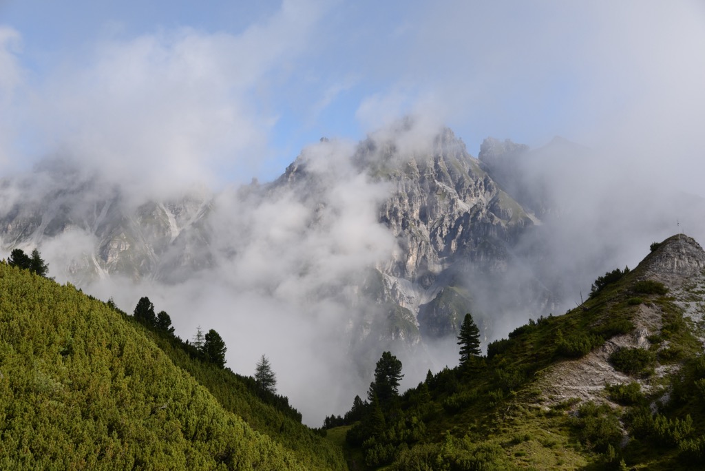 Marchreisenspitze hides behind clouds during summer. Kalkkogel