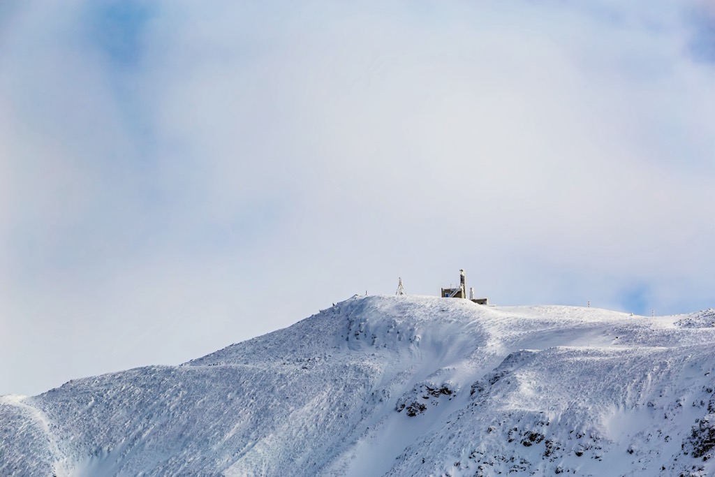 A prominent weather station marks Tarcu Peak. Muntii Tarcu