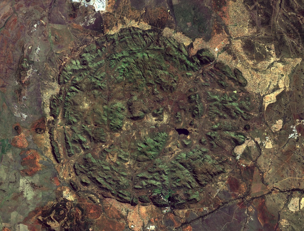 A satellite image of the Pilanesberg; geologists estimate that the volcano once measured over 7,000 meters (23,000 ft). Over the last billion or so years, it has been whittled down to an island of hills by the forces of erosion. North West