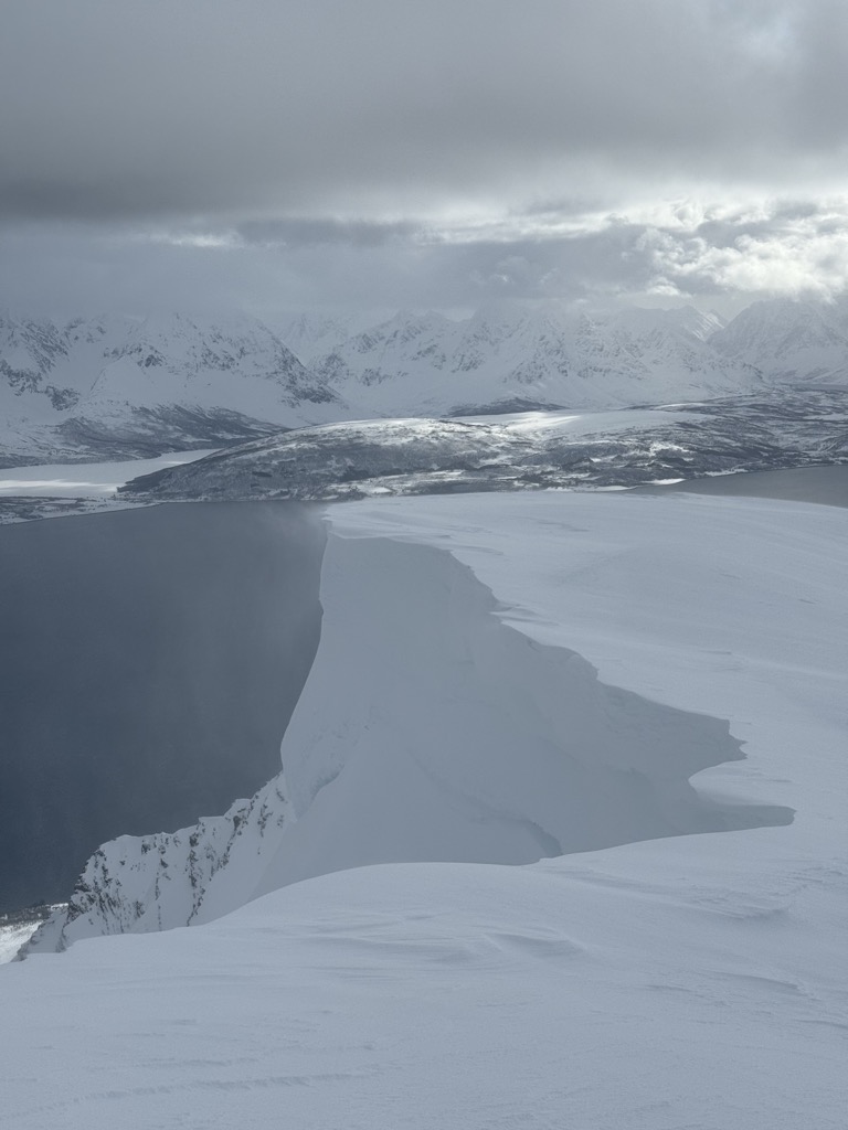 An example of the large cornices in Norway on Ullstinden, with a view towards the Lyngen Alps. Photo: Denis Bulichenko. Norway