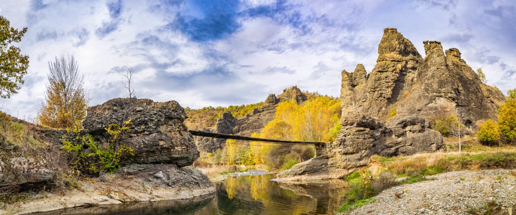 A pedestrian suspension bridge crosses the Pčinja River at Vrazji Kamen (Devil's Rock). Pcinja River Valley