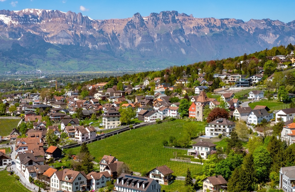 Aerial view of Vaduz with mountains in the background. Raetikon