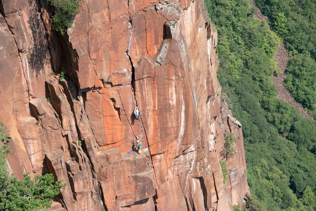 Trad climbing involves following crack systems up a rock and placing temporary pieces of protection to back up a fall. Rock Climbing