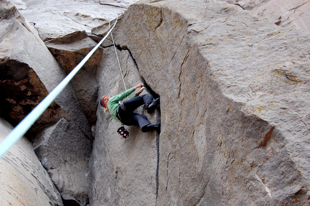 Lay-backing makes crack climbing a lot easier, but it’s hard to lead, so hardcore crack climbers sometimes look down upon it as a crutch. Notice how this woman is top-roping and not leading the climb. Rock Climbing