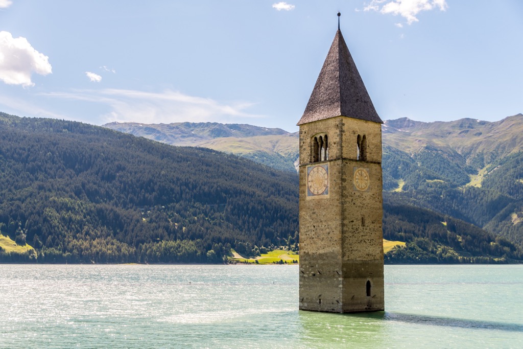 The submerged 14th-century clocktower at Graun im Vinschgau. Sesvenna Alps