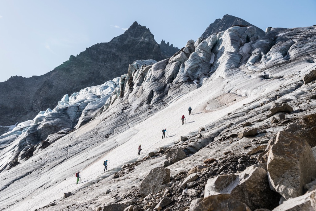 Hikers on Ochsentaler Glacier ascending Piz Buin. Silvretta Alps
