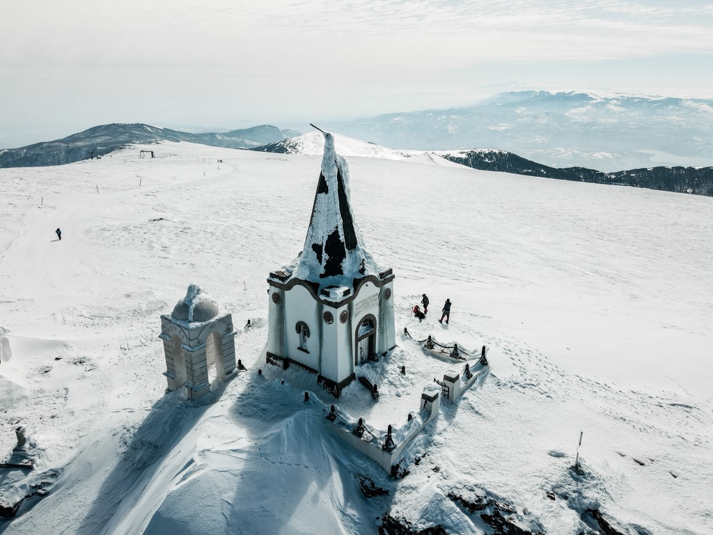 Church of Apostolos Petros during winter, with the ski area in the background. Voras Mountains