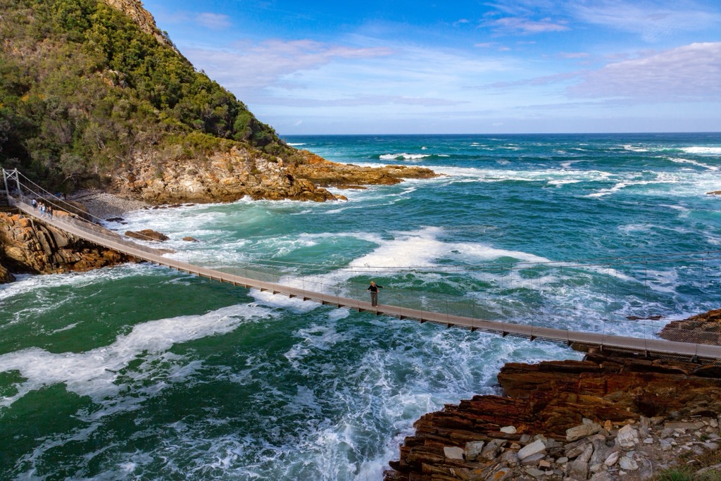 A pedestrian suspension bridge fords the imposing mouth of the Storms River. Western Cape