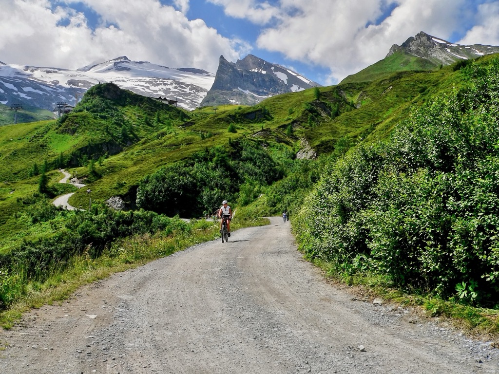 A cyclist enjoying the Tuxer Joch mountain pass. Zillertal Alps