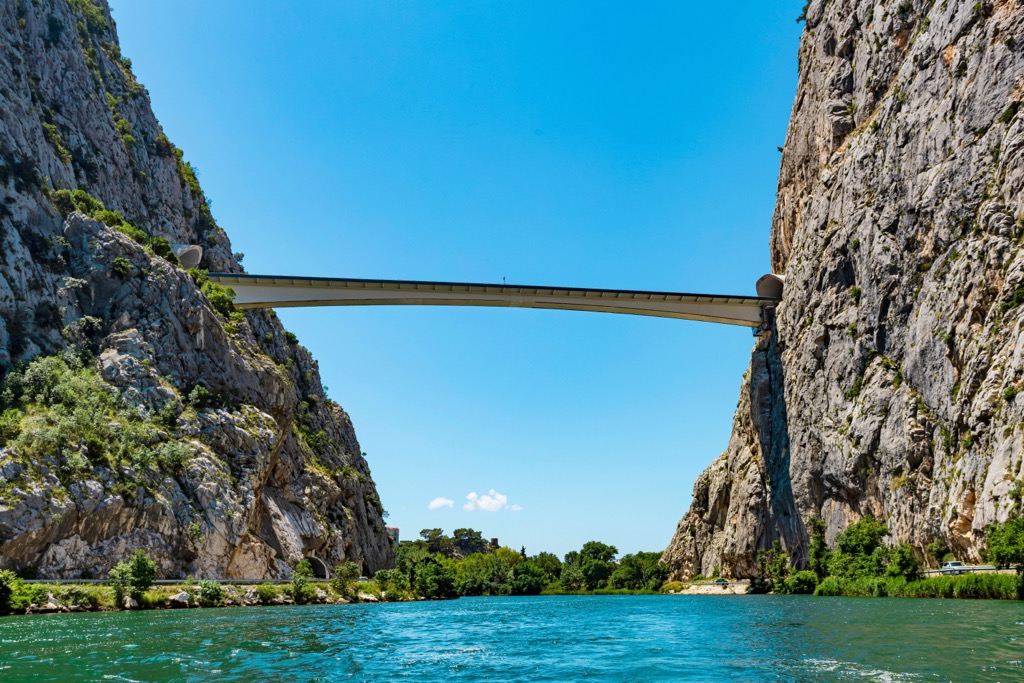 Towering limestone cliffs flank the Cetina River around the town of Omis Dinara Nature Park