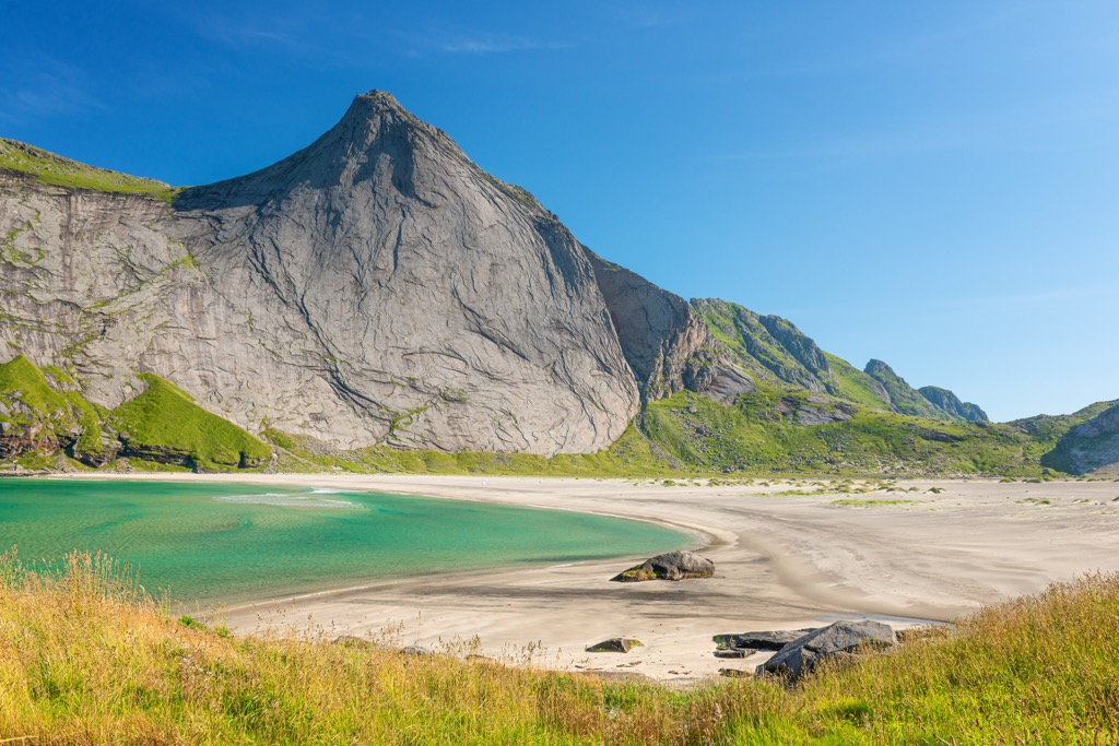 The granite walls of Helvetestinden rising above the sea in the Lofoten Islands, Norway