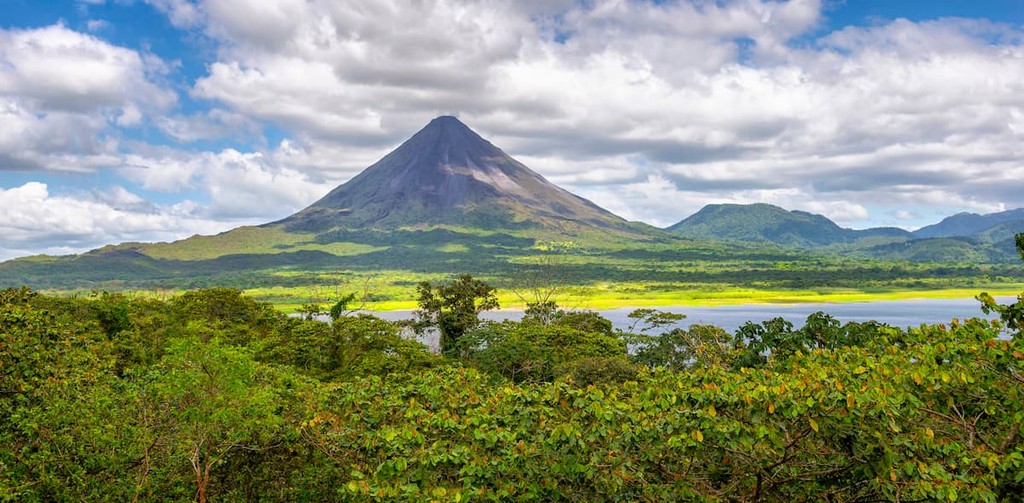 Panorama of volcano Arenal reflected on wonderful picturesque lake, La Fortuna, Costa Rica