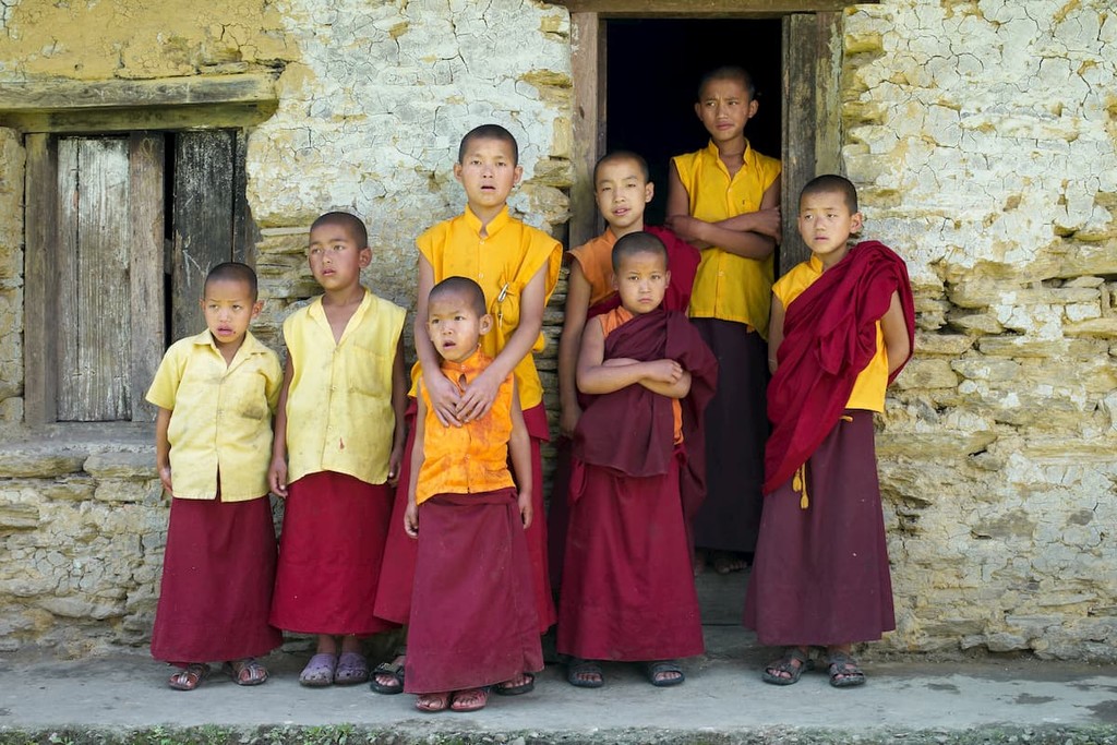 Little monks in front of a house at Sangachoeling Gompa on May 05, 2010 in Sikkim, India